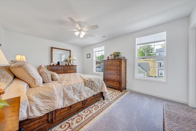 bedroom with visible vents, baseboards, ceiling fan, and light carpet