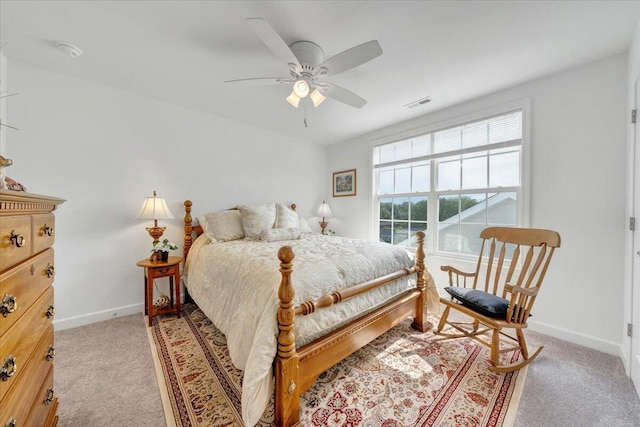 bedroom with light colored carpet, a ceiling fan, baseboards, and visible vents