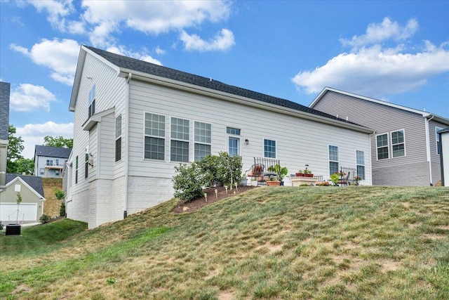 rear view of property with a yard