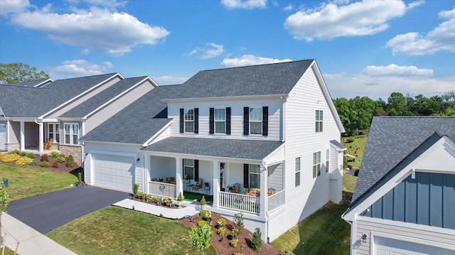 view of front of home featuring covered porch, board and batten siding, a garage, aphalt driveway, and a shingled roof