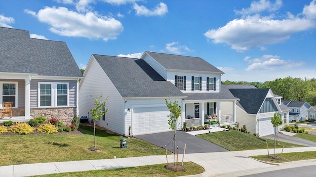 view of front of house with a garage, a front lawn, covered porch, stone siding, and driveway