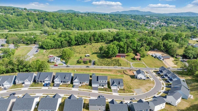 aerial view featuring a residential view, a mountain view, and a wooded view