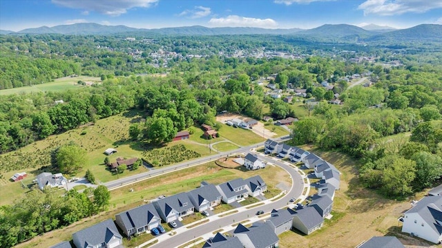 birds eye view of property with a residential view, a mountain view, and a wooded view