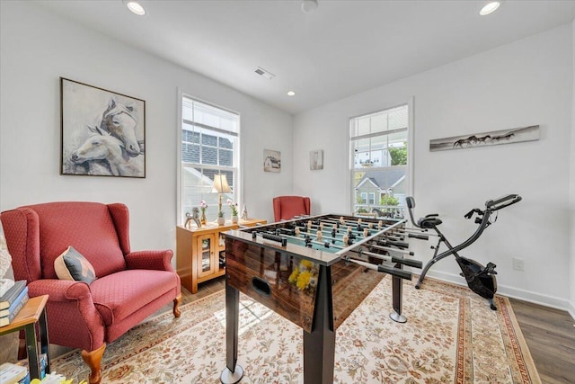 game room featuring baseboards, recessed lighting, wood finished floors, and visible vents