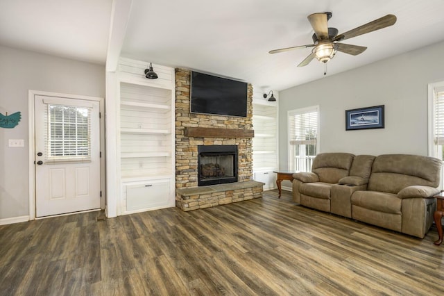 1169 Mountain Creek Ln, Big Island, VA 24526 - living room featuring dark wood-style flooring, a ceiling fan, a stone fireplace, and baseboards