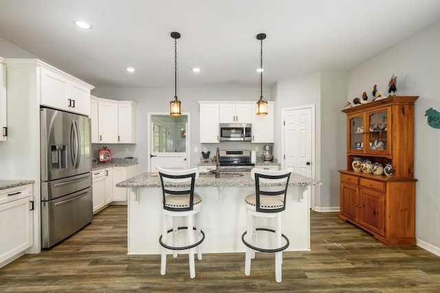1169 Mountain Creek Ln, Big Island, VA 24526 - kitchen featuring appliances with stainless steel finishes, white cabinetry, dark wood-style floors, a kitchen bar, and recessed lighting