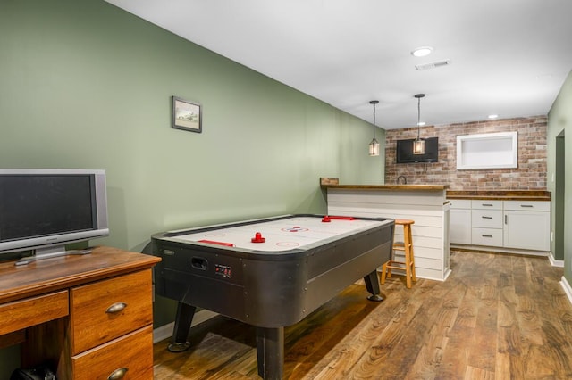 1169 Mountain Creek Ln, Big Island, VA 24526 - rec room with wood finished floors and brick wall
