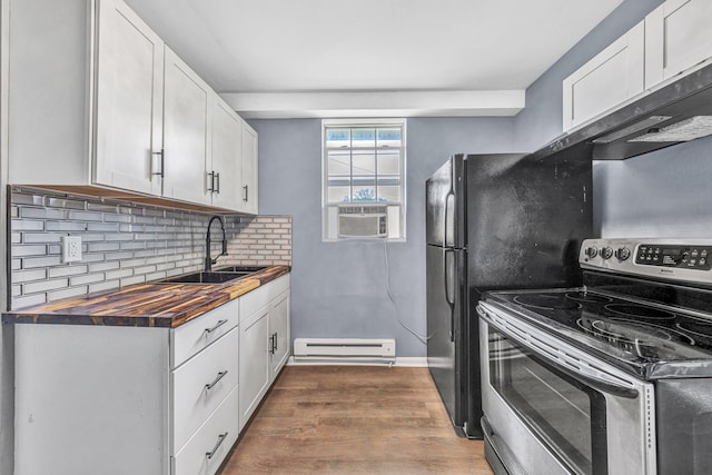 kitchen featuring stainless steel range with electric cooktop, wooden counters, a baseboard radiator, a sink, and dark wood finished floors