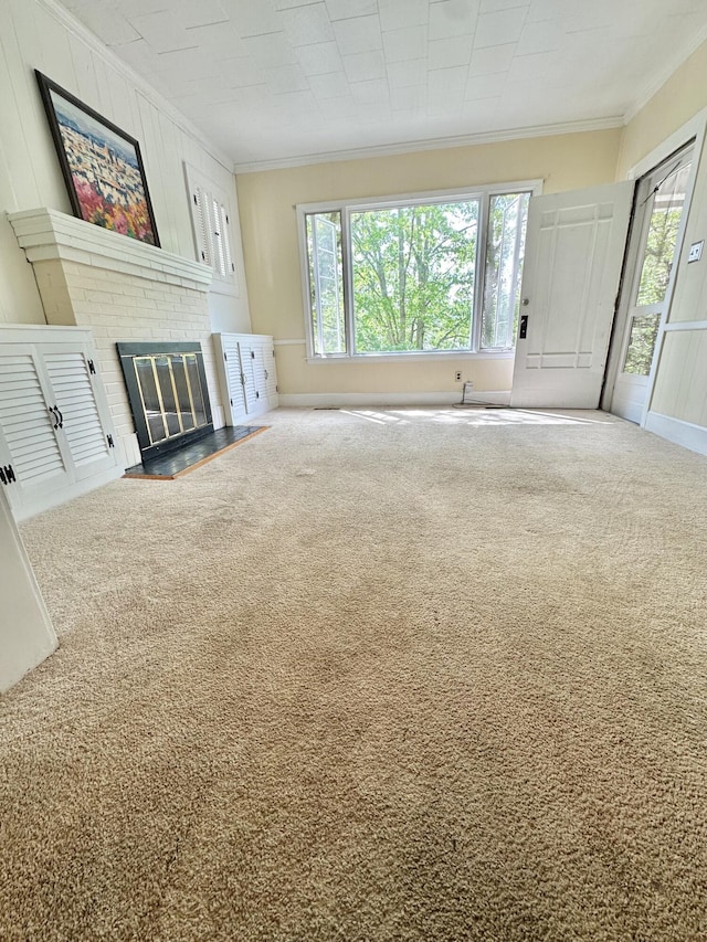 unfurnished living room featuring ornamental molding, carpet, and plenty of natural light