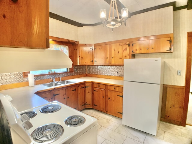 kitchen with a notable chandelier, light countertops, a sink, and white appliances