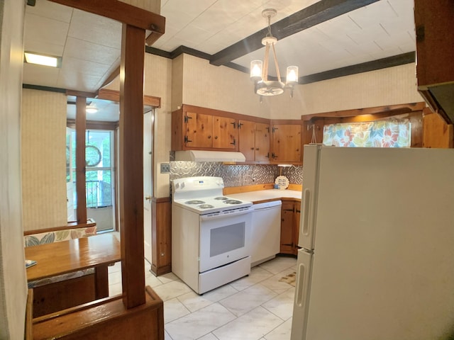 kitchen with white appliances, tasteful backsplash, under cabinet range hood, light countertops, and a notable chandelier