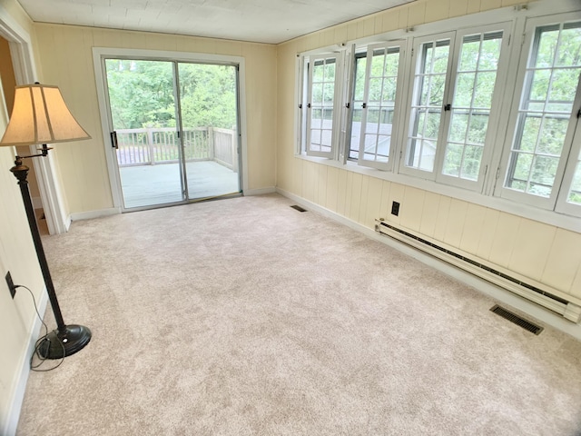 interior space with a baseboard radiator, french doors, plenty of natural light, and visible vents
