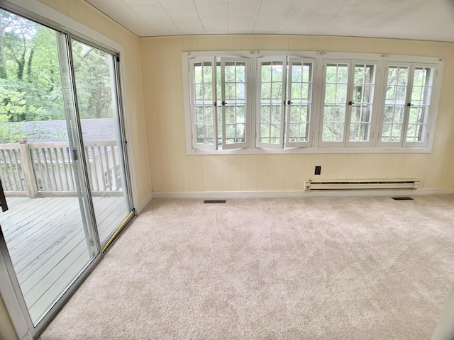 unfurnished room featuring visible vents, baseboards, baseboard heating, and carpet floors