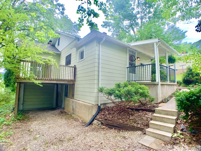 view of side of home with covered porch and a garage