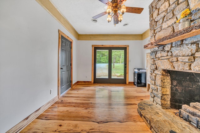 living area with baseboards, a textured ceiling, ceiling fan, and hardwood / wood-style flooring