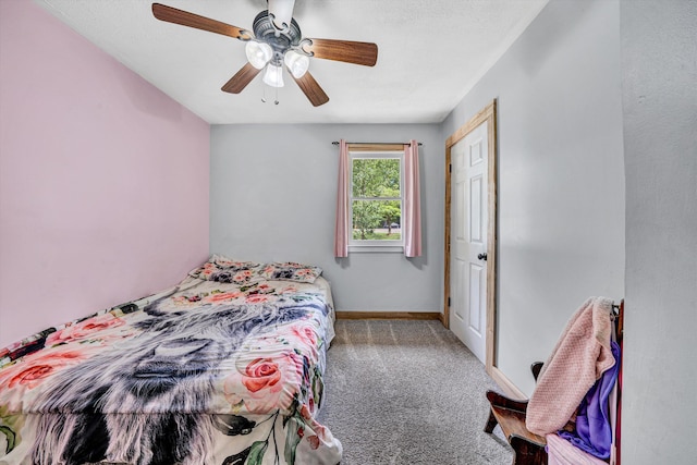 carpeted bedroom featuring baseboards and ceiling fan