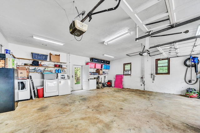 garage featuring washer and dryer, freestanding refrigerator, and a garage door opener