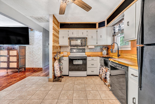 kitchen featuring visible vents, ceiling fan, a textured ceiling, white cabinets, and black appliances