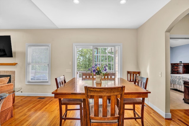 80 Farmers Cir, Moneta, VA 24121 - dining space featuring arched walkways, light wood-type flooring, baseboards, a tiled fireplace, and recessed lighting