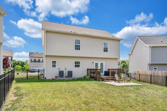 back of house with a lawn, central air condition unit, a wooden deck, and a fenced backyard