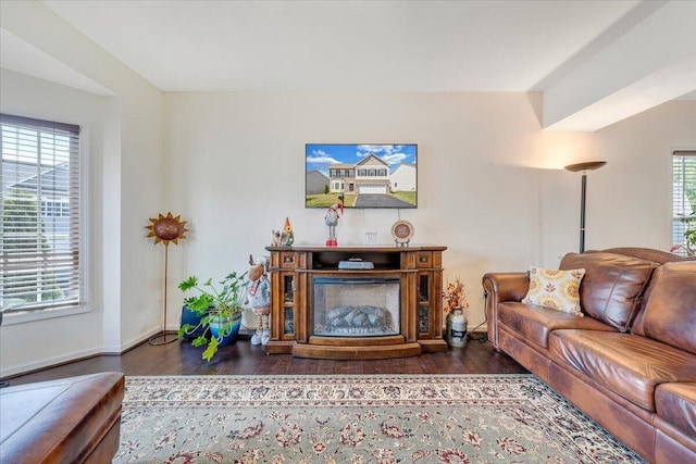 living area with wood finished floors and baseboards