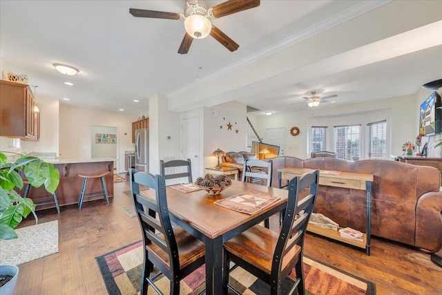 dining area with wood finished floors, stairs, crown molding, ceiling fan, and recessed lighting