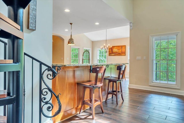 bar with pendant lighting, baseboards, plenty of natural light, and dark wood-style floors