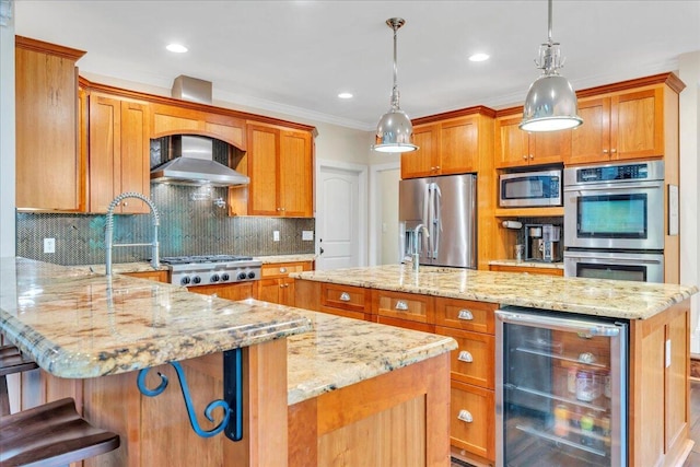 kitchen featuring a kitchen island with sink, appliances with stainless steel finishes, a peninsula, beverage cooler, and wall chimney exhaust hood