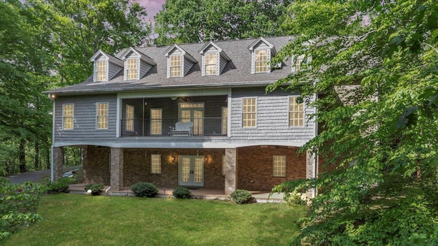view of front facade with french doors, brick siding, and a front yard