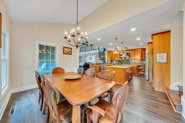 dining area with an inviting chandelier, baseboards, and dark wood finished floors