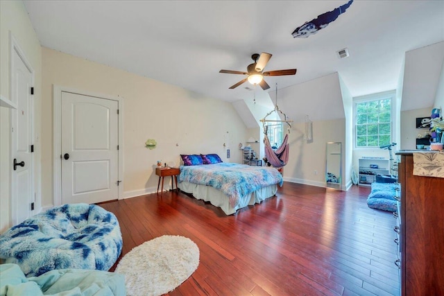 bedroom with baseboards, visible vents, lofted ceiling, and hardwood / wood-style floors