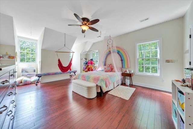 bedroom featuring wood-type flooring, baseboards, visible vents, and multiple windows