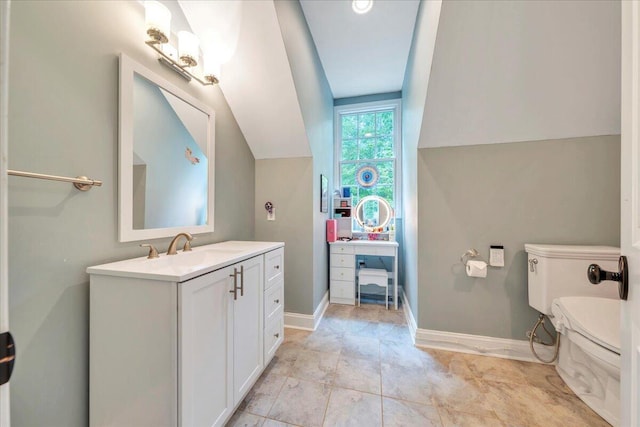 bathroom with vanity, baseboards, and toilet