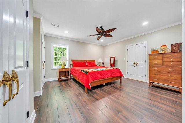 bedroom with visible vents, ornamental molding, and dark wood finished floors