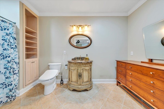 bathroom featuring toilet, baseboards, ornamental molding, and vanity