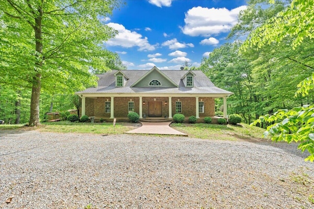 cape cod home featuring a porch