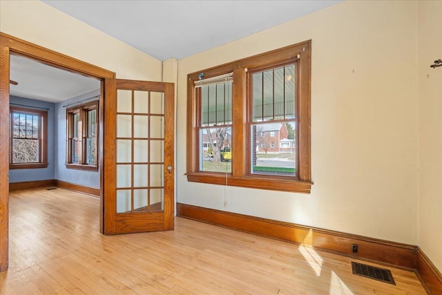 spare room with light wood-style flooring and baseboards