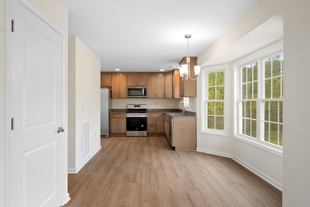 5595 New Pleasant Way, Salem, VA 24153 - kitchen featuring a notable chandelier, baseboards, a sink, stainless steel appliances, and light wood-type flooring