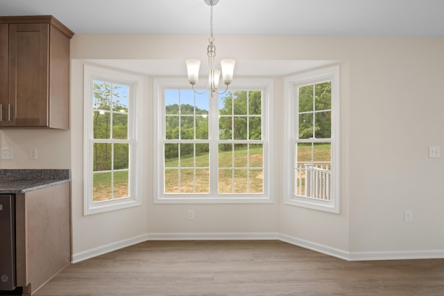 5595 New Pleasant Way, Salem, VA 24153 - unfurnished dining area featuring baseboards, a wealth of natural light, a notable chandelier, and light wood-type flooring