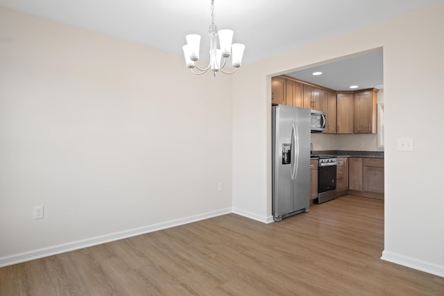 5595 New Pleasant Way, Salem, VA 24153 - kitchen with stainless steel appliances, wood finished floors, baseboards, and a notable chandelier