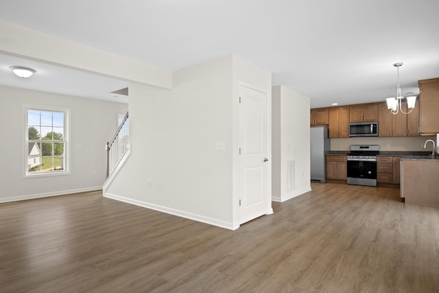 5595 New Pleasant Way, Salem, VA 24153 - unfurnished living room with a chandelier, wood finished floors, baseboards, and stairs