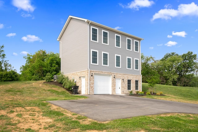 5595 New Pleasant Way, Salem, VA 24153 - view of home's exterior with a yard, aphalt driveway, an attached garage, and brick siding