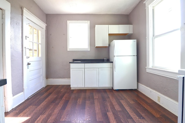 1412 9th St SE, Roanoke, VA 24013 - kitchen featuring freestanding refrigerator, white cabinetry, and dark wood-style flooring