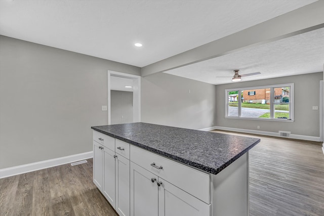 kitchen featuring white cabinetry, visible vents, dark wood-style flooring, baseboards, and ceiling fan