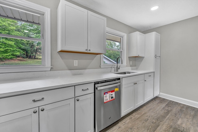 kitchen with white cabinetry, light countertops, a sink, and dishwasher