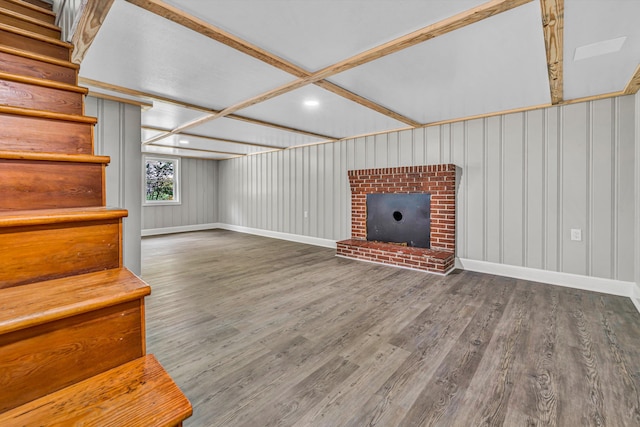 below grade area featuring wood finished floors, baseboards, a fireplace, and stairs