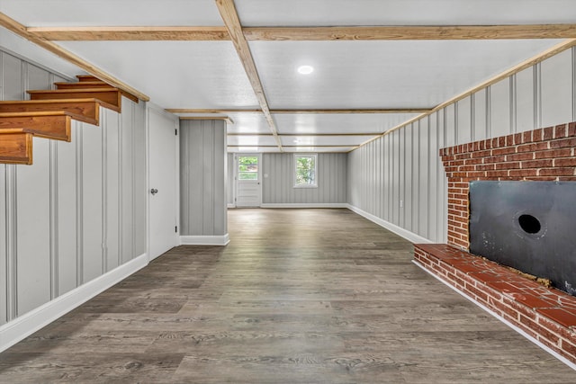 unfurnished living room with stairs, wood finished floors, beamed ceiling, coffered ceiling, and baseboards