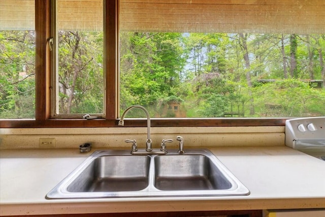 interior details with a sink and light countertops
