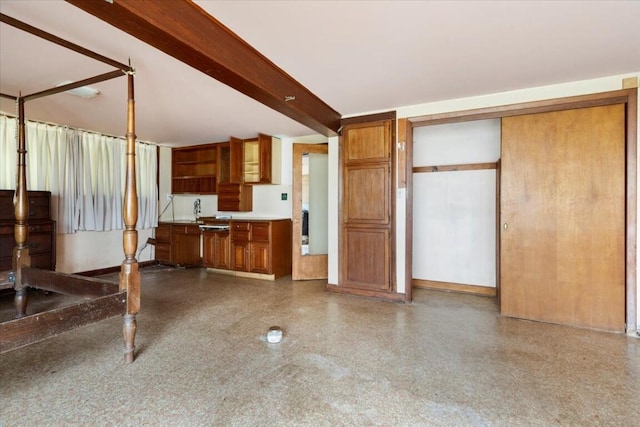 kitchen featuring open shelves and brown cabinetry