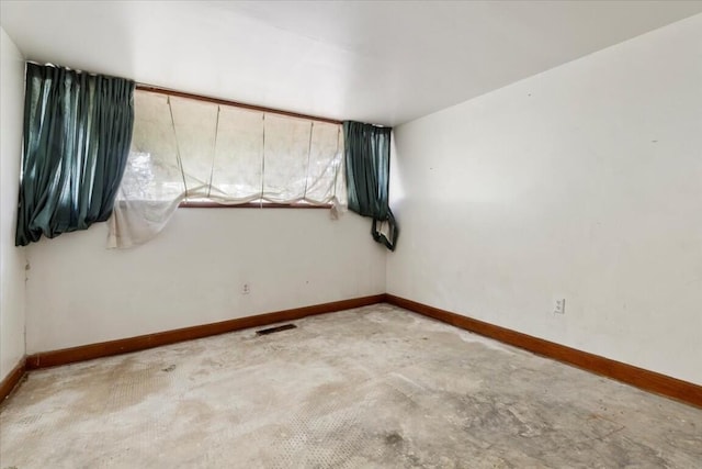 spare room featuring baseboards and visible vents